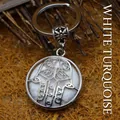 Ethnic silver-toned Hamsa hand keychain featuring a white howlite gemstone inlay design - Howlite