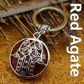 Handcrafted ethnic style Hamsa hand keychain featuring a vibrant red agate stone inlay - Red Agate