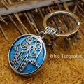 Ethnic Hamsa hand pendant keychain featuring a blue turquoise patterned stone inlay - Blue Turquoise