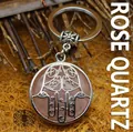 Handcrafted ethnic style Hamsa hand keychain featuring a natural rose quartz stone - Rose Quartz