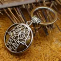 Ethnic style Tiger's eye gemstone keychain featuring intricate silver hamsa hand filigree pendant - Tiger's Eye