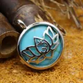 Elegant round turquoise pendant necklace with intricate silver-tone lotus flower box design - Turquoise