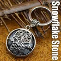 Ethnic Hamsa hand keychain featuring a natural snowflake obsidian gemstone pendant. - Snowflake Obsidian