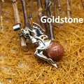 Elegant silver fairy pendant necklace featuring a sparkling brown goldstone crystal ball - Gold Sandstone
