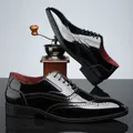 Detailed view of black shiny patent leather brogue oxfords with classic wingtip carving - 39 / Black