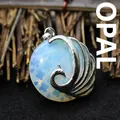 Exquisite silver peacock pendant featuring an opalescent round stone in hollow metal - Opal