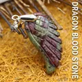 Artisanal carved wing-shaped pendant made of natural dragon blood stone on twigs - Dragon Blood Stone