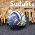 Elegant silver-toned peacock pendant featuring a polished round blue vein stone inlay - Blue Sodalite