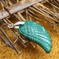 Polished green malachite wing-shaped carved pendant necklace accessory with silver-toned bail - Malachite
