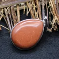 Elegant teardrop-shaped orange goldstone pendant necklace with silver metal bezel - Gold Sandstone