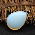Elegant teardrop-shaped synthetic opal gemstone pendant with a polished silver bail - Opal