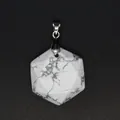 Detailed macro view of hexagonal faceted white stone pendant with natural grey veins - White