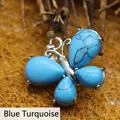 Elegant butterfly pendant crafted with natural blue turquoise stones and silver-tone metal - Blue Turquoise