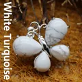 Elegant butterfly shaped pendant featuring white turquoise stones in a silver setting - Howlite
