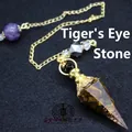 Baroque style crystal healing pendulum with natural tiger eye stone chips inside - Tiger's Eye