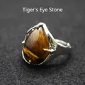 Silver-toned adjustable ring featuring a teardrop-shaped tiger's eye gemstone cabochon. - Tiger's Eye