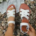 Detailed view of stylish white flat cross strap Roman beach sandals on a pebble background - 36 / Roman Style (68#) / White
