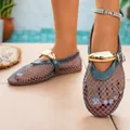 Detail view of blue-grey mesh hollow flat sandals with a decorative gold buckle - Dark Blue