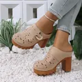 Stylish beige platform mules featuring floral cutouts and gold buckle shown on a model - 36 / Khaki