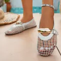 Close-up detail of stylish white mesh hollow-out flat sandals with gold ornament. - 35 / White
