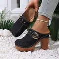 Detail showing the star-patterned hollowed upper and gold buckle of the black mules - 36 / Black