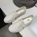Detailed macro view of women's cream white casual sneakers with textured leather - 35 / Off White