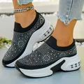 Detailed macro view of black slip-on wedge sneakers featuring sparkling rhinestones. - 36 / Black