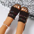 Close-up of brown suede flat slides featuring trendy fringe and colorful rhinestone accents. - 36 / Chestnut
