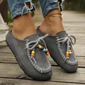 Grey suede slip-on loafers with colorful bead decorations on a wooden boardwalk. - 36 / Gray