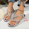 Close-up detail of silver braided women's flat sandals with 1cm heel height measurement - Silver