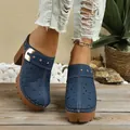 Detail view of navy blue floral cut-out clogs with chunky heel and gold buckle - 36 / Blue