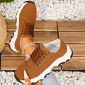 Detailed macro view of brown suede thick-sole women's sneakers on wooden planks - 36 / Brown