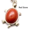 Small turtle shaped pendant featuring an oval red crystal stone in a silver finish - Red Jasper