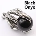 Macro detail of a vintage silver dragon claw pendant holding a polished black onyx sphere. - Black Agate