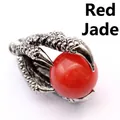 Detailed macro view of a vintage medieval style dragon claw pendant with red jade bead - Red Jade