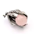 Detailed macro view of a vintage silver dragon claw pendant holding a pink bead. - Rose Quartz