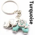 Decoratieve sleutelhanger in de vorm van een olifant met turquoise steen en zilveren afwerking - Turkoois