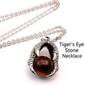 Detailed view of a medieval silver dragon claw pendant with a tiger eye gemstone - Dragon Claw Pendant (With Necklace) / Tiger's Eye