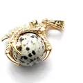 Gold plated dragon claw pendant necklace featuring a round dalmatian stone bead - Dalmatian Jasper