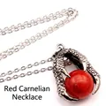 Close-up of a vintage medieval silver dragon claw pendant with a large red bead on a chain - Dragon Claw Pendant (With Necklace) / Red Jade