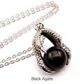 Close-up view of a medieval dragon claw pendant holding a polished black agate bead on a chain. - Dragon Claw Pendant (With Necklace) / Black Agate