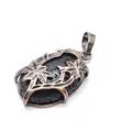 Vintage bronze floral cage pendant featuring a natural black volcanic lava stone - Lava Stone