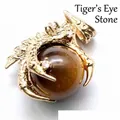 Golden dragon claw pendant featuring a polished round tiger eye gemstone for jewelry making - Tiger's Eye