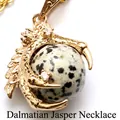 Detailed golden dragon claw pendant clutching a dalmatian stone sphere on a gold chain. - Dalmatian Jasper with Necklace