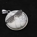 Elegant white turquoise round pendant featuring black crystal sunglasses design detail - Howlite
