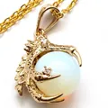 Golden dragon claw pendant necklace featuring a round white opal bead and inlaid crystals - With Necklace / Opal