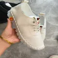 Detailed view of a cream soft leather flat mom shoe with a comfortable jelly sole. - 35 / White