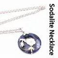 Elegant blue sodalite circular pendant necklace featuring a delicate white flower charm - Necklace Set / Blue Sodalite
