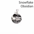Elegant silver dolphin wave pendant featuring round snowflake obsidian stone inlay - Snowflake Obsidian