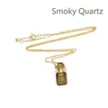 Élégant collier avec pendentif flacon de parfum en quartz fumé et chaîne dorée. - Quartz fumé / Or
